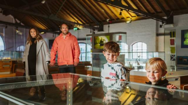 Two parents with two children in a museum