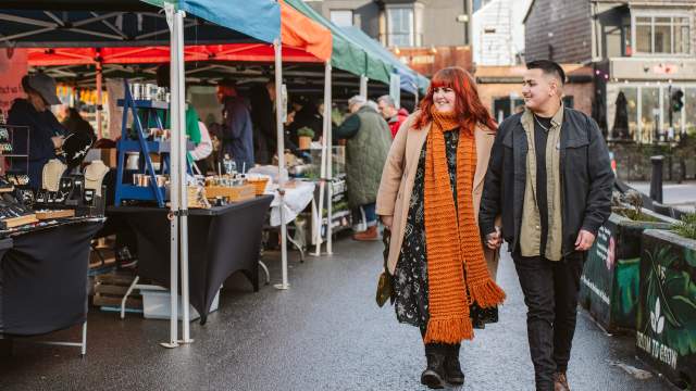 A couple walking through Uplands Market