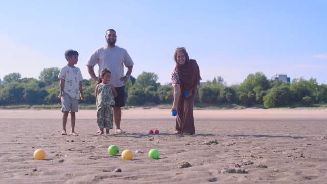 A family playing games on Swansea Beach