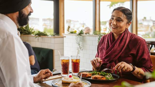 A couple enjoying food at the Green Room Swansea