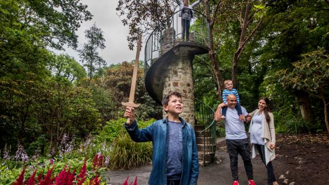 A family standing in front of the tower at Clyne Gardens