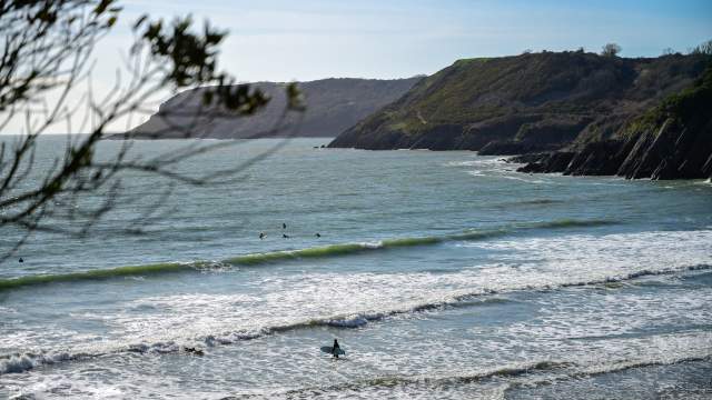 People surfing at Caswell bay