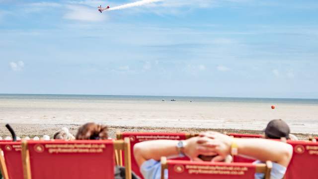 People sitting on deck chairs at the Wales Airshow