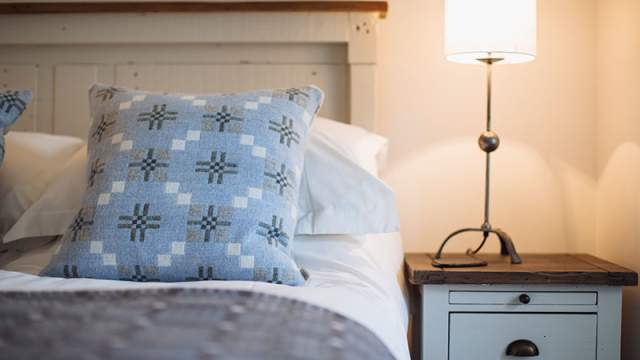 Hotel room bed with Welsh tapestry cushion