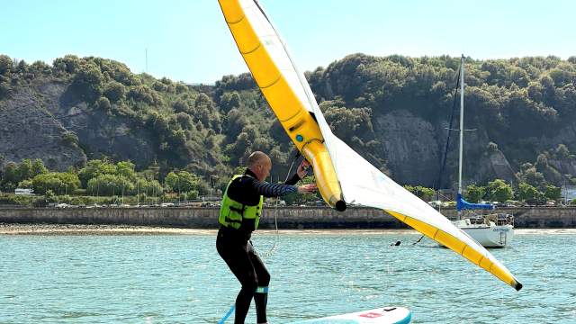 A man wingsurfing with SUP Gower