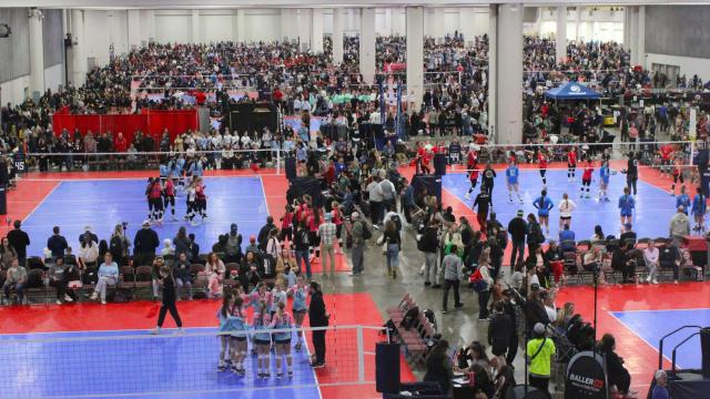 Volleyball courts inside a convention center with volleyball players