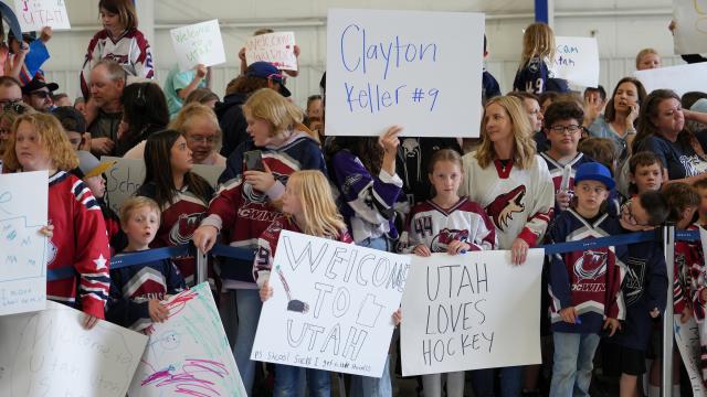 Fans holding up signs welcoming the new Utah Hockey Club to Utah
