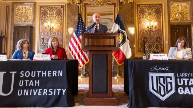 Utah govenour is at a podium making an announcement.