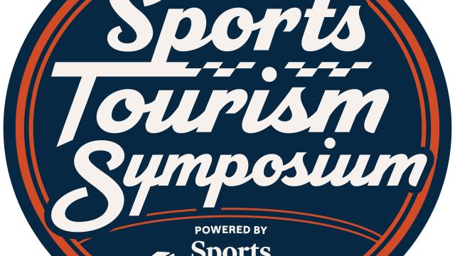 Ball with the words Sports Tourism Symposium powered by Sports Salt Lake on it