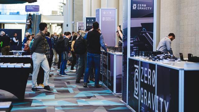 Conference attendees of Zero Gravity Summit walking around in the Salt Palace Convention Center.