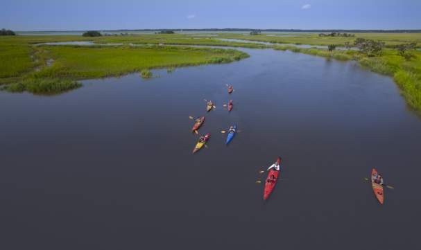 A group of kayakers paddle through the marsh in Golden Isles, Georgia