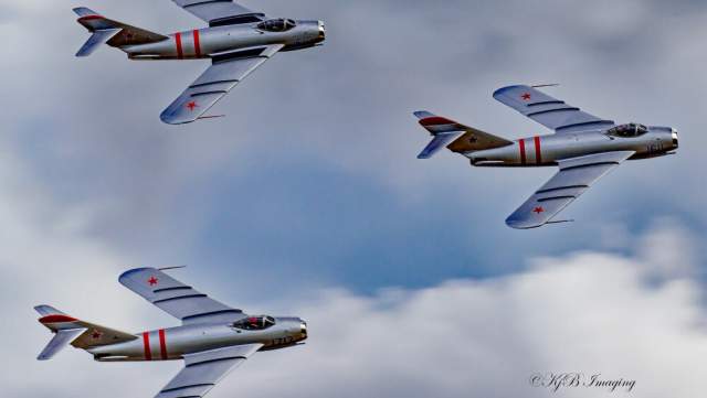 a group of three soviet mig figther jets flying in a triangular formation