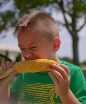 boy eating corn