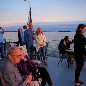 people taking photos of the sunset over Lake Champlain on the Spirit of Ethan Allen