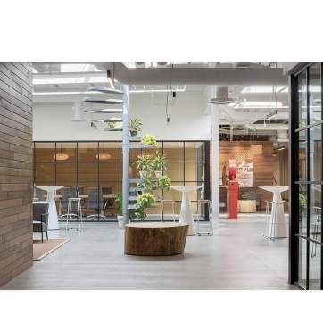 Indoor meeting venue at Hula Lakeside, featuring high ceilings, earthy decor, and an open concept seating area.