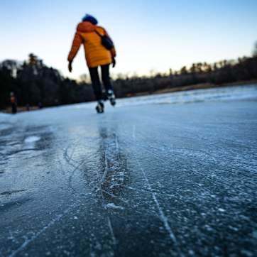 Skater glides across the ice on a winter day in Burlington, Vermont