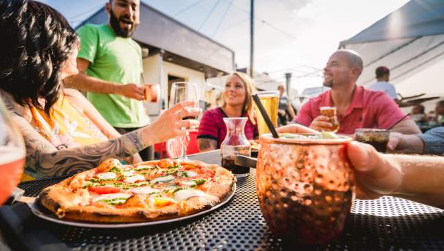 People enjoying pizza on an outdoor patio