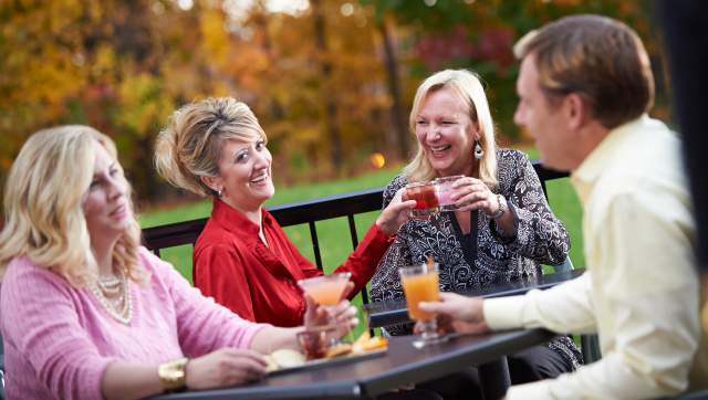 People drinking on a patio during fall