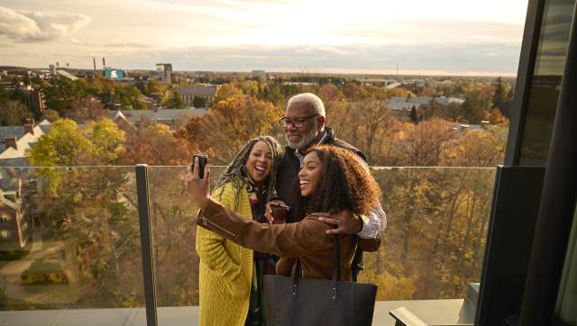 Family taking a selfie with Michigan State campus in the background