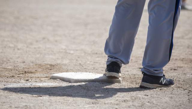 Softball player standing on a base