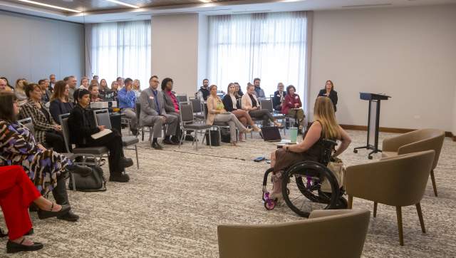 Kristy Durso speaking in front of attendees