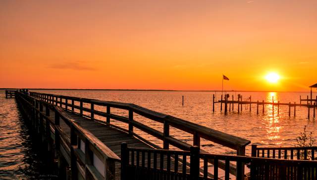 Pier extending into the James River at sunset