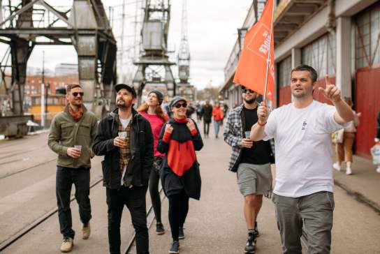 A group of people on the Cider Box walking tour of Bristol outside the M Shed local history museum on Bristol's Harbourside - credit Yuup