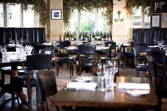Image of dining room in Hotel du Vin with bottles of wine in background