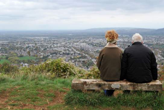 People sat on a bench on Leckhampton Hill, Cheltenham
