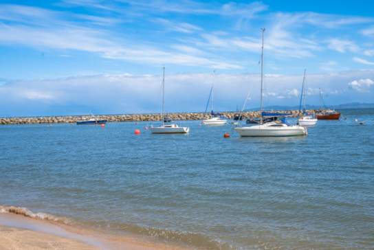 View of boats on the water at Rhos-on-Sea