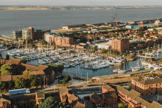 Aerial view of Hull Marina with boats, waterfront buildings, footbridge and the Humber Estuary in the background