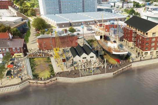 Aerial view of the North End Shipyard redevelopment in Hull, showing restored historic buildings, the Spurn Lightship, waterfront walkways, cranes, and visitors exploring the newly designed heritage site alongside the River Hull.