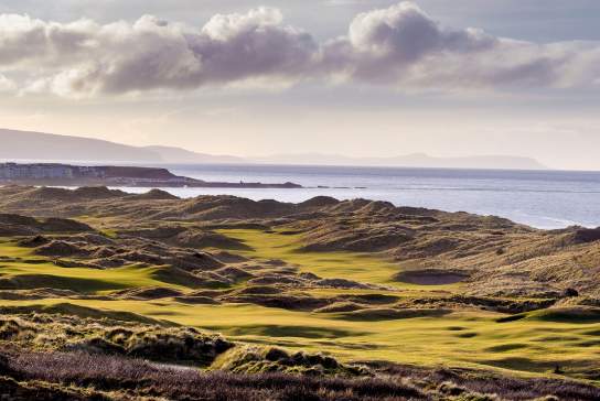 Aerial of the greens and fairways at Royal Portrush Golf Course overlooking the sea