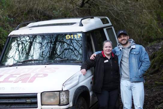Influencer Rory Martin taking a photo in front of a jeep with an instructor at Todd's Leap.