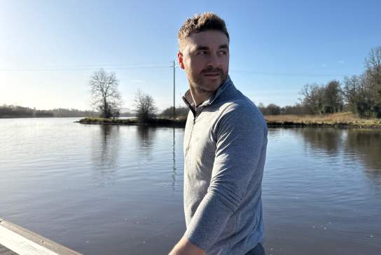 Influencer Rory Martin on a jetty on a sunny day at Killyhevlin Hotel and Lodges.