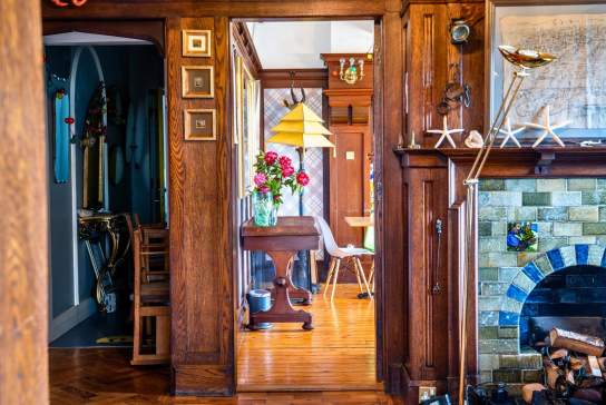 A beautifully decorated hallway can be seen, along with a glimpse of a living room in Cairn Bay Lodge
