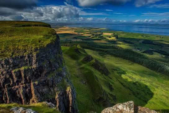 Top of Binevenagh over looking green farmland with Donegal in the distance