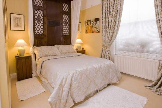 a made up bed at Laurel Villa Guest House