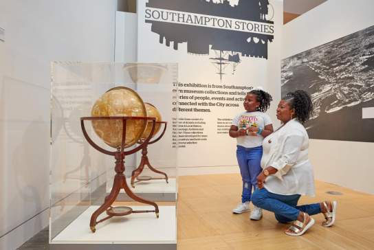Adult and child looking at globes in Seacity Museum