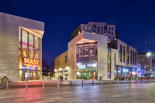 The cultural quarter at night showing John Hansard Gallery and Mayflower Studios buildings with signage lit up