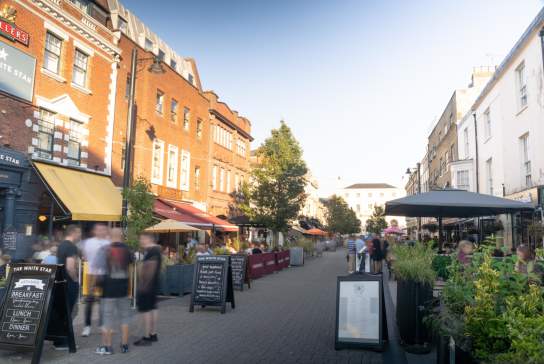 Street with restaurants either side and people walking