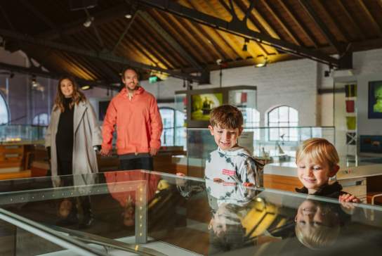 Two parents with two children in a museum