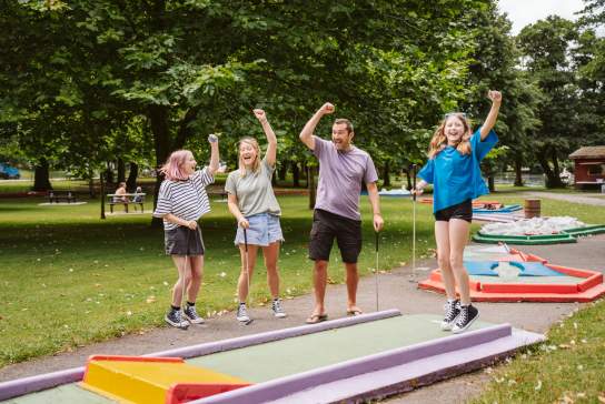 Family playing mini golf in Singleton Park