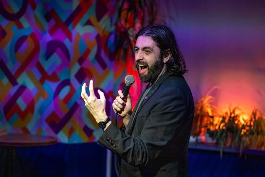 A comedian speaking into a microphone.