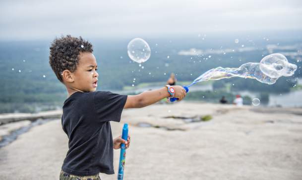 Kid playing with bubbles