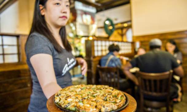 woman holding dish of food