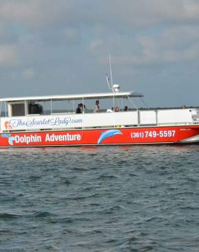 A red and white passenger boat out on the water