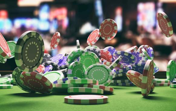 casino chips thrown and bouncing on table game
