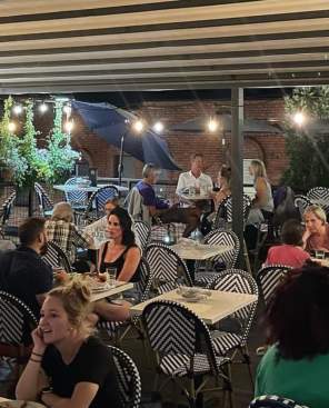 Diners on the rooftop patio at The Roost