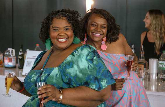 Two women getting mimosas at the Stack N Style event at the Brownwood Event Center